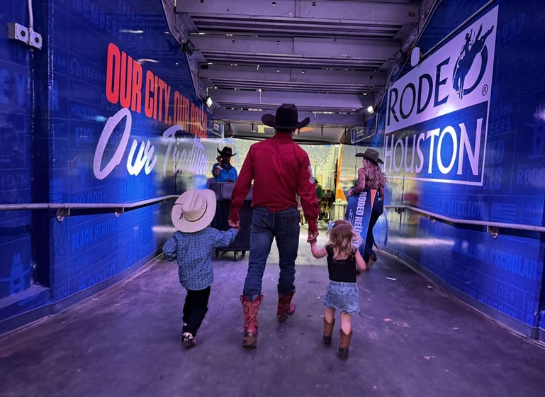 Bareback rider Garrett Shadbolt, of Merriman, Neb., walking into Rodeo Houston with two of his greatest fans, son George and daughter Mavis, by his side. Courtesy photo